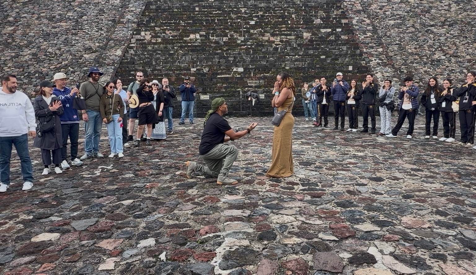 Rodney proposing to LaShanna in Mexico City, surrounded by an applauding crowd